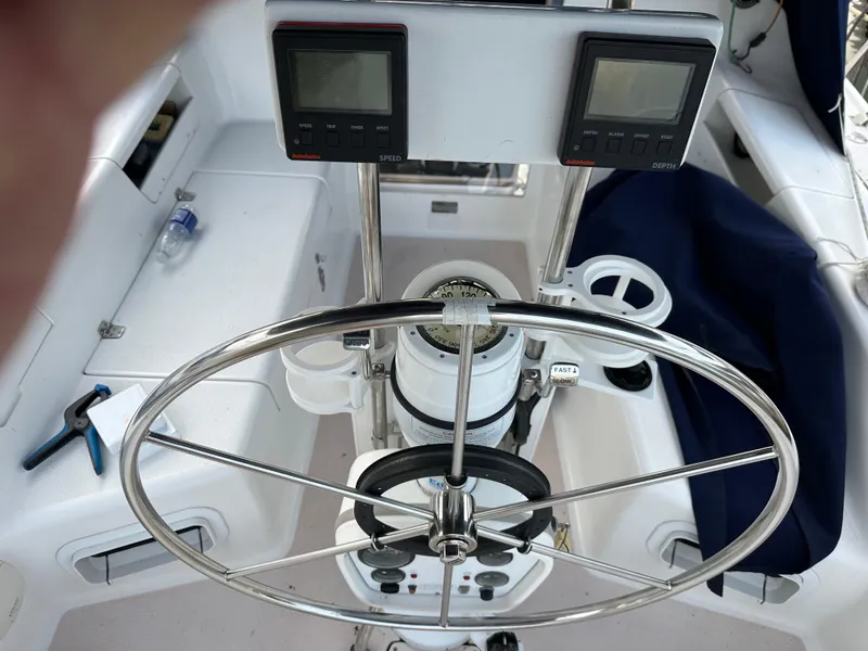 Slide: The Image of Cockpit of a 1997 Catalina 28 MkII sailboat with steering wheel and navigation instruments. - 12