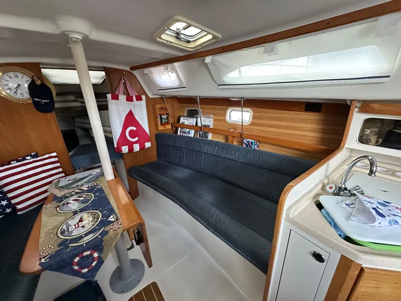 Slide: The Image of Interior of a 1997 Catalina 28 MkII sailboat with cozy seating and nautical decor. - 16