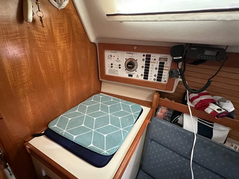 Slide: The Image of Interior of a 1997 Catalina 28 MkII sailboat with control panel and seating area. - 17