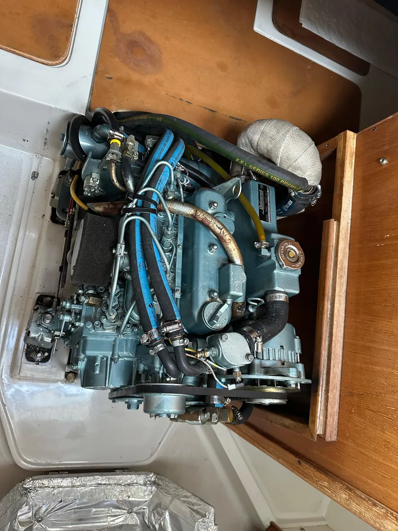 Slide: The Image of Catalina 28 MkII 1997 engine compartment with visible hoses and components. - 19