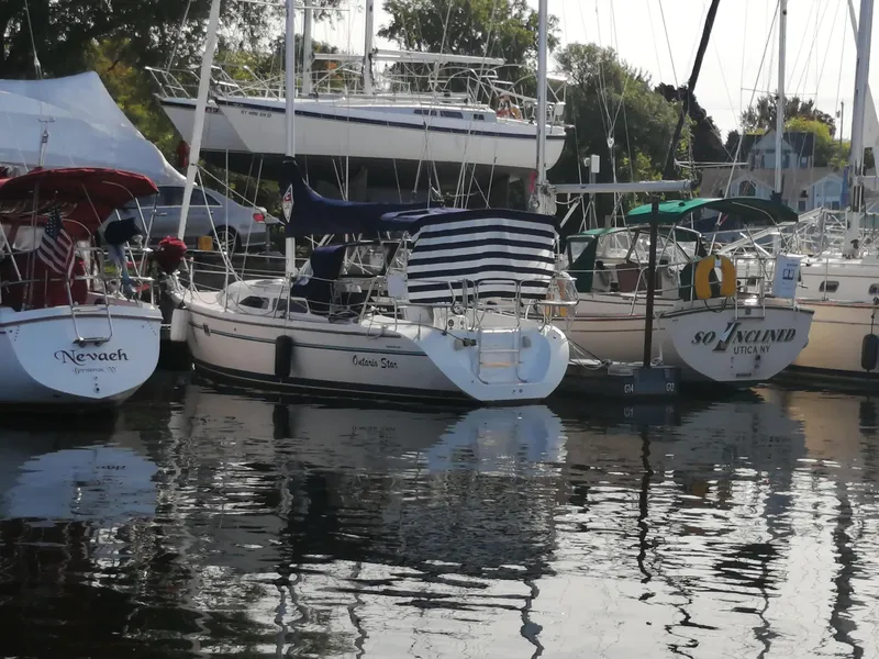Slide: The Image of Boats docked at a marina, featuring a 1997 Catalina 28 MkII sailboat. - 2