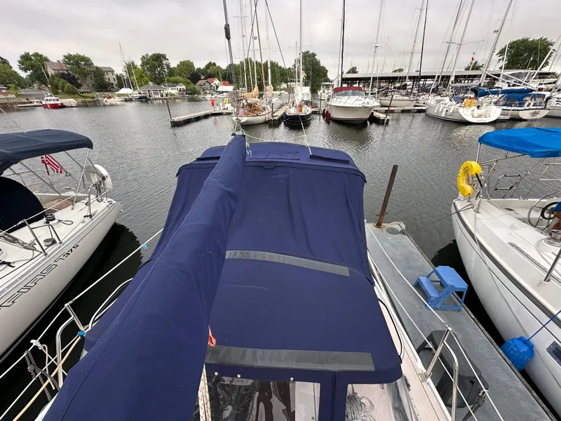 Slide: The Image of 1997 Catalina 28 MkII sailboat docked in a marina, surrounded by other boats. - 23