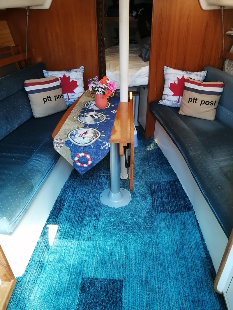 Slide: The Image of Cozy interior of a 1997 Catalina 28 MkII sailboat with nautical decor and blue carpet. - 5