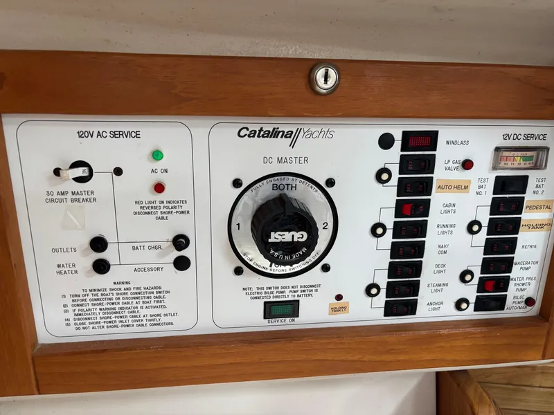 Slide: The Image of Electrical control panel of a 1997 Catalina 28 MkII yacht with various switches and indicators. - 7