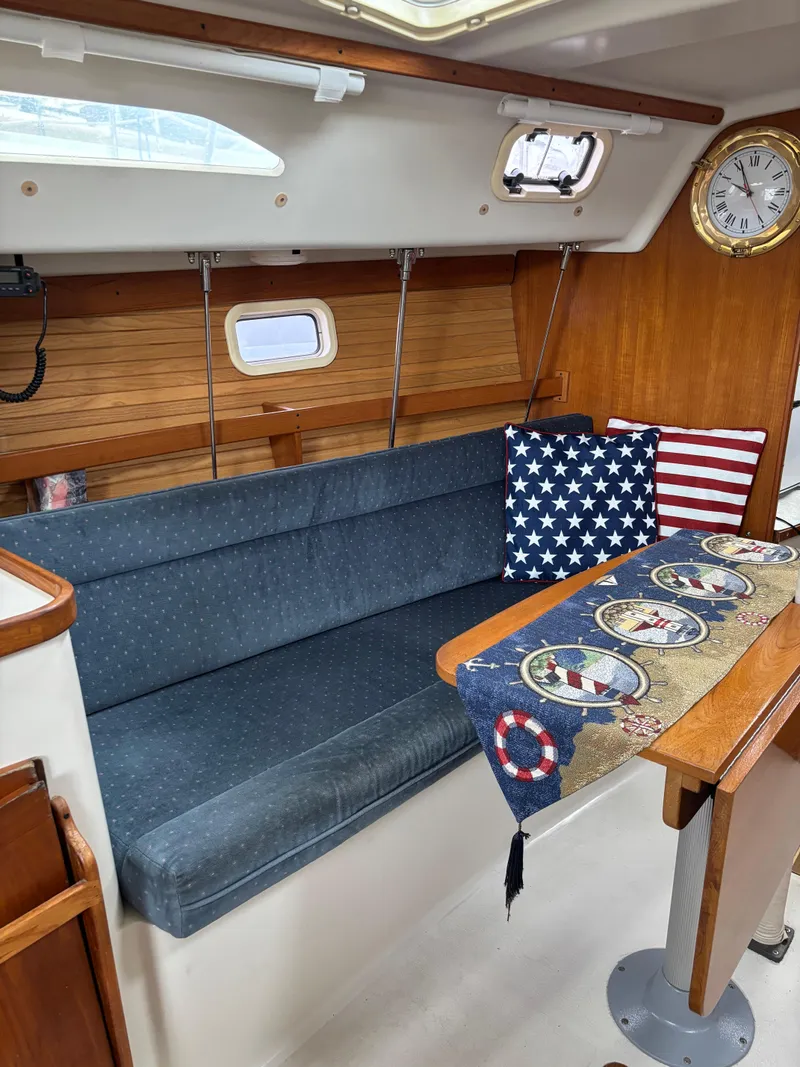 Slide: The Image of Interior of 1997 Catalina 28 MkII sailboat with blue seating and nautical decor. - 8