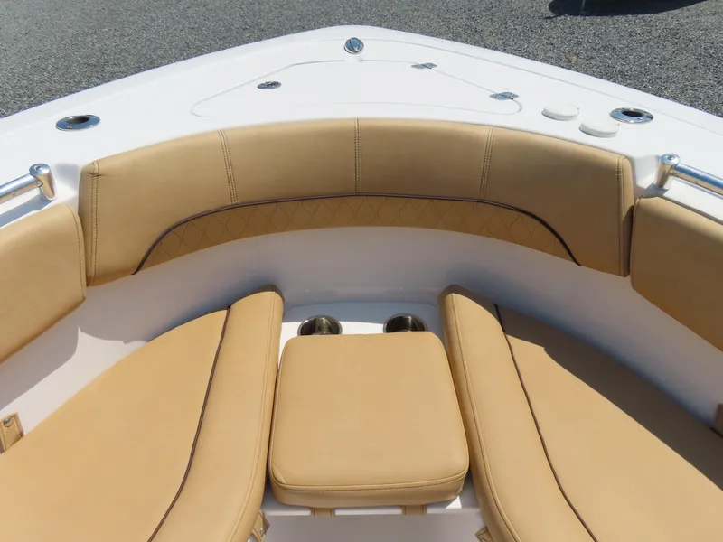 Slide: The Image of 2018 Sportsman Heritage 251 Center Console boat with tan cushioned seating. - 11