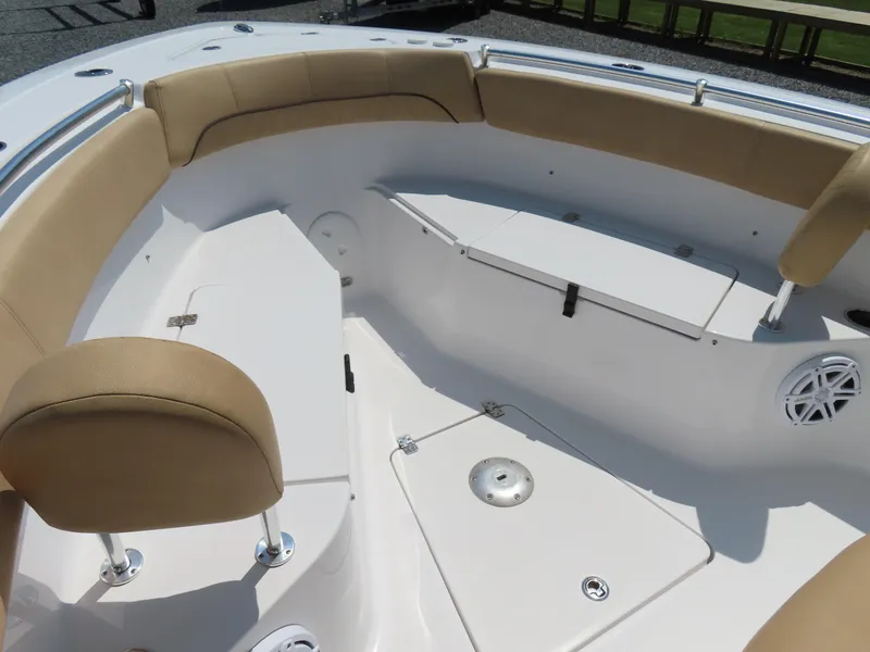 Slide: The Image of 2018 Sportsman Heritage 251 Center Console boat interior with cushioned seating and storage compartments. - 12