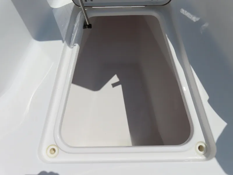 Slide: The Image of 2018 Sportsman Heritage 251 Center Console storage compartment, open and empty. - 14