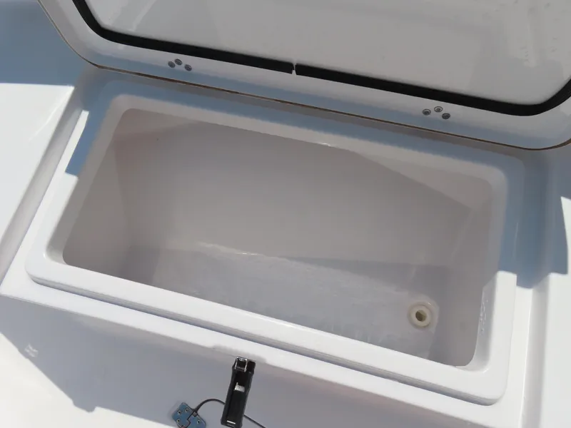 Slide: The Image of Open storage compartment on 2018 Sportsman Heritage 251 Center Console boat. - 16