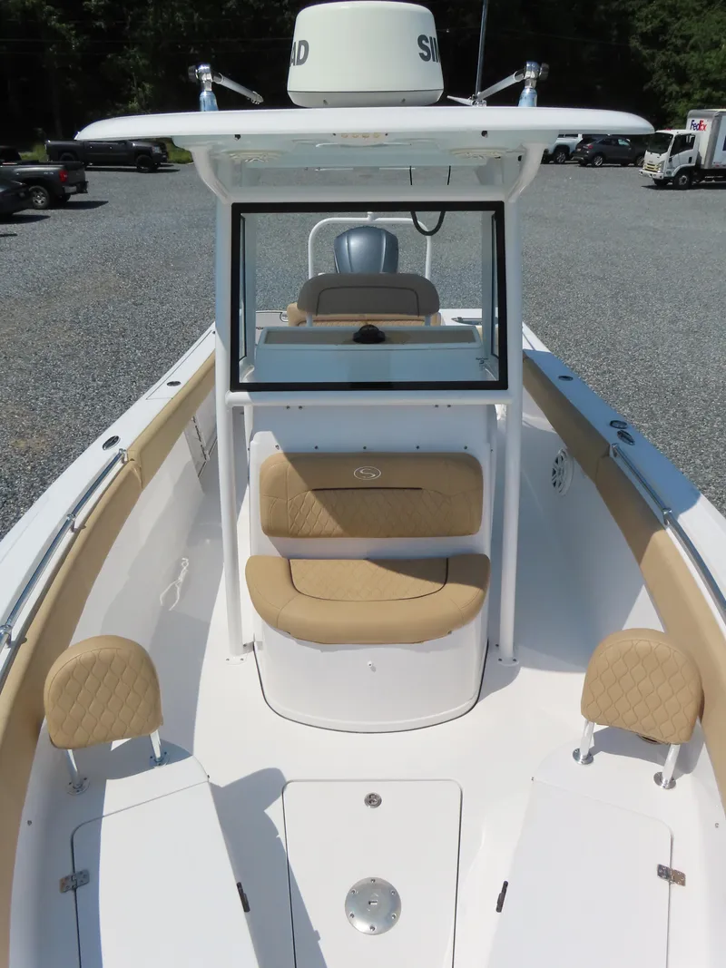 Slide: The Image of 2018 Sportsman Heritage 251 Center Console boat with tan seating and white deck. - 19