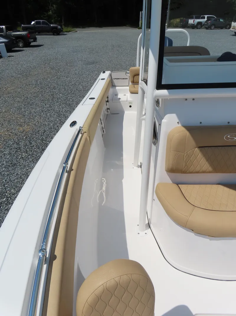 Slide: The Image of 2018 Sportsman Heritage 251 Center Console boat interior with tan seating and white deck. - 20
