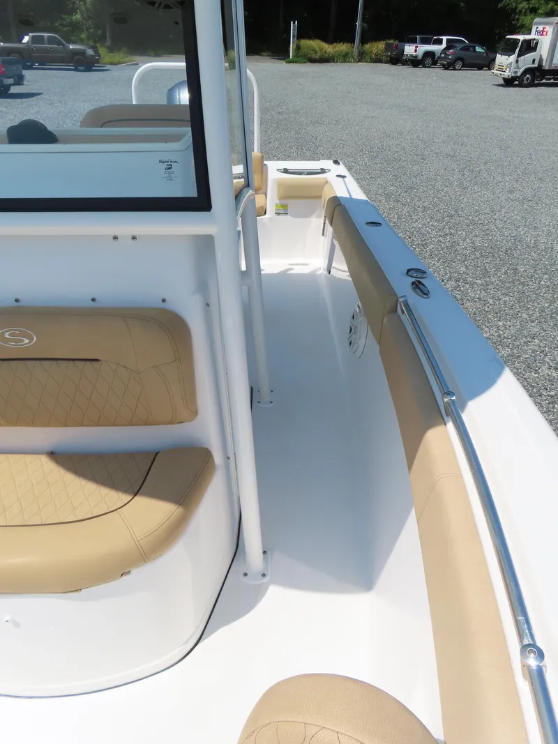 Slide: The Image of 2018 Sportsman Heritage 251 Center Console boat interior with tan seating and white deck. - 21