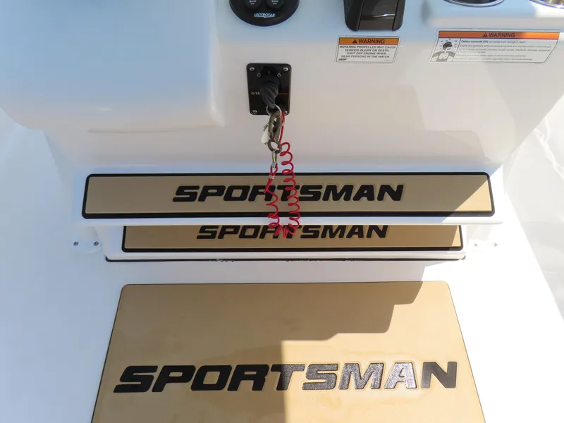 Slide: The Image of 2018 Sportsman Heritage 251 Center Console boat interior with branded mats and safety features. - 30