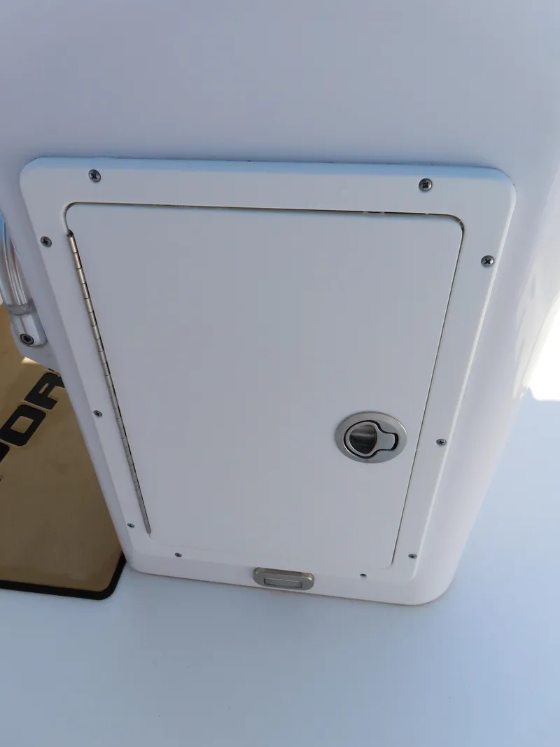 Slide: The Image of 2018 Sportsman Heritage 251 Center Console storage compartment with secure latch. - 32