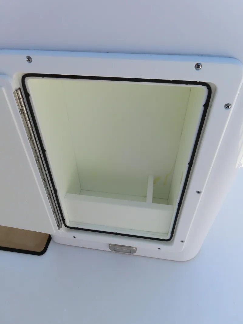 Slide: The Image of Open storage compartment on 2018 Sportsman Heritage 251 Center Console boat. - 33
