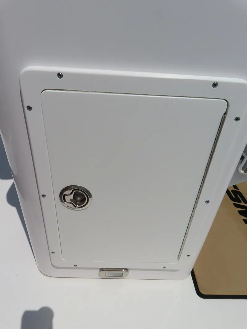 Slide: The Image of 2018 Sportsman Heritage 251 Center Console storage compartment with secure latch. - 34