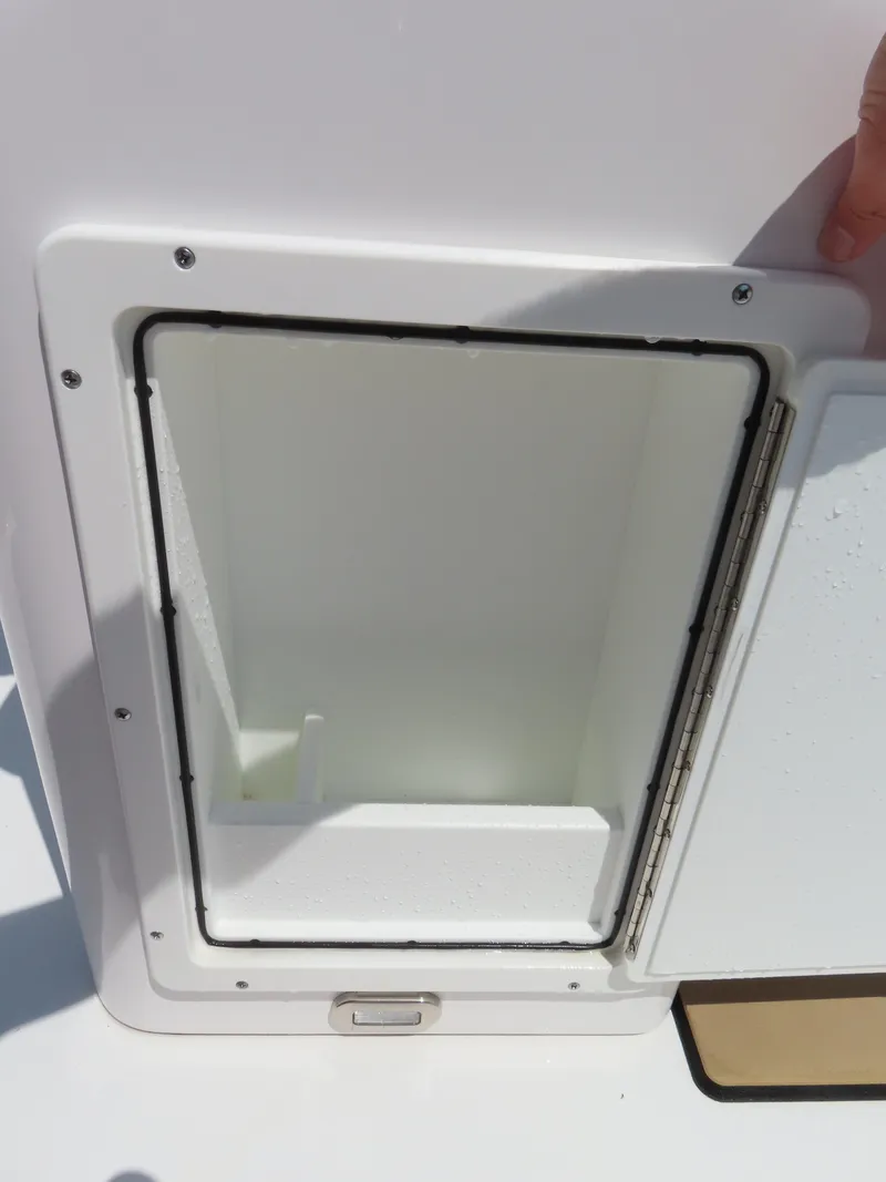 Slide: The Image of Open storage compartment on 2018 Sportsman Heritage 251 Center Console boat. - 35