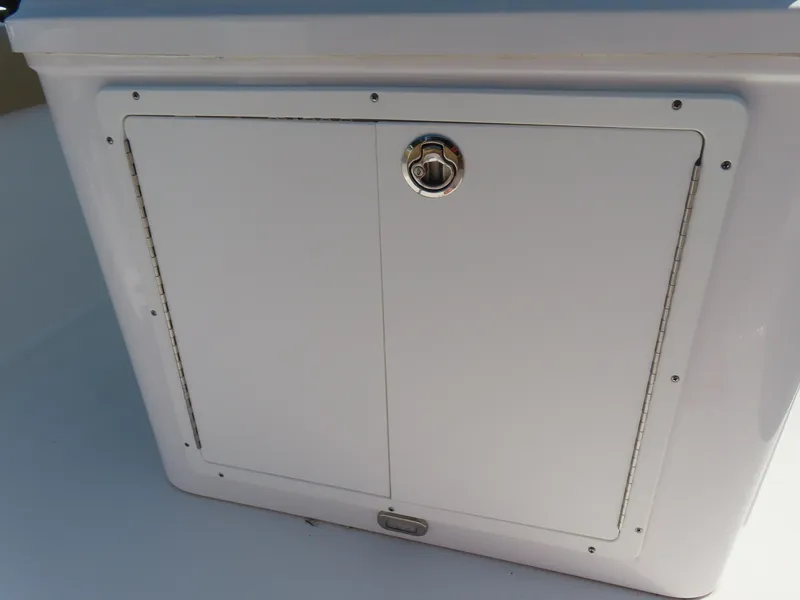 Slide: The Image of 2018 Sportsman Heritage 251 Center Console storage compartment with secure latch. - 36