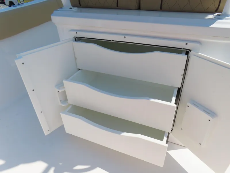 Slide: The Image of Open storage drawers on 2018 Sportsman Heritage 251 Center Console boat. - 37