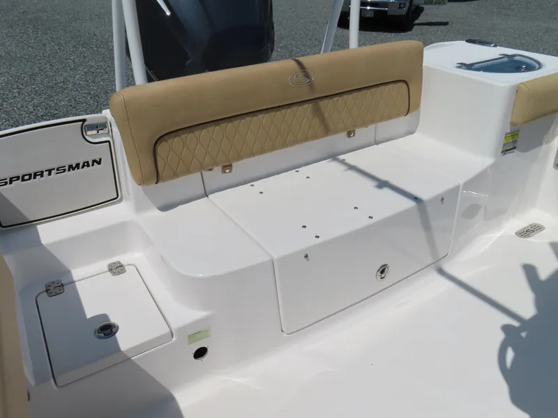 Slide: The Image of 2018 Sportsman Heritage 251 Center Console boat seating area with tan upholstery. - 39