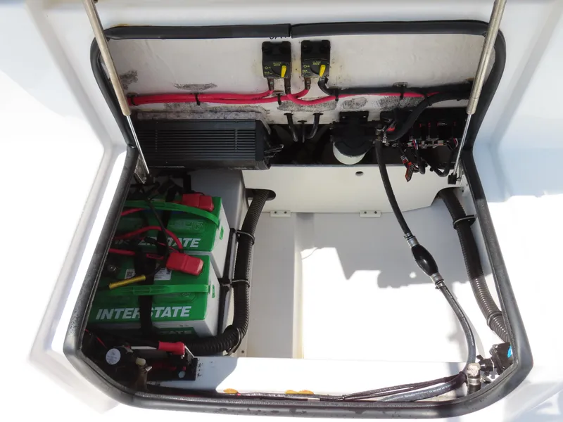 Slide: The Image of 2018 Sportsman Heritage 251 Center Console battery compartment with wiring and Interstate batteries. - 41