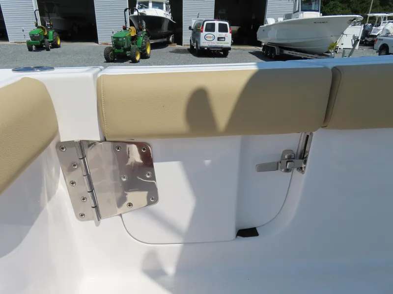 Slide: The Image of 2018 Sportsman Heritage 251 Center Console interior with beige seating and stainless steel hardware. - 45