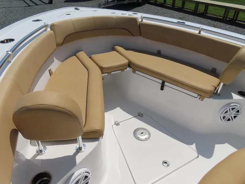 Slide: The Image of 2018 Sportsman Heritage 251 Center Console boat with tan cushioned seating in the bow area. - 8