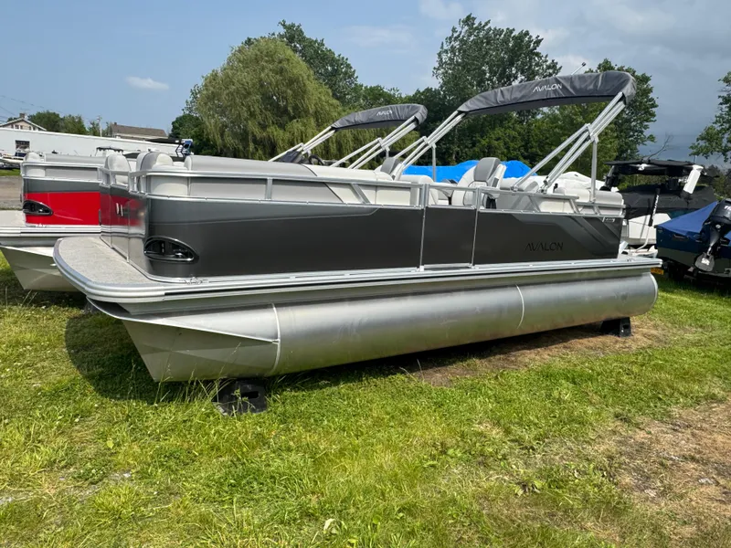 The Image of 2025 Avalon Venture QL pontoon boat on grass, featuring sleek design and modern amenities. - 1