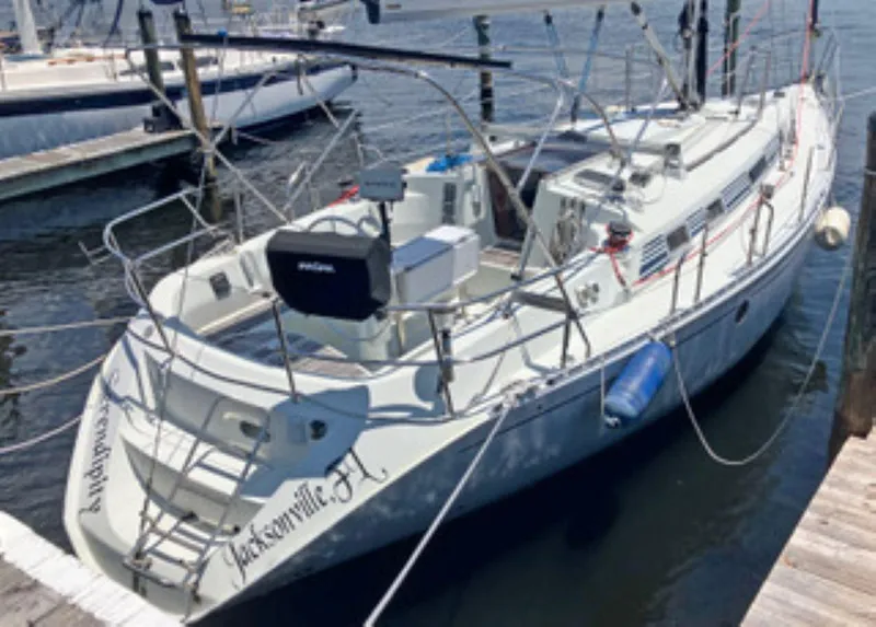 The Image of 1991 Beneteau MOORINGS 38 sailboat docked in Jacksonville, FL marina. - 1