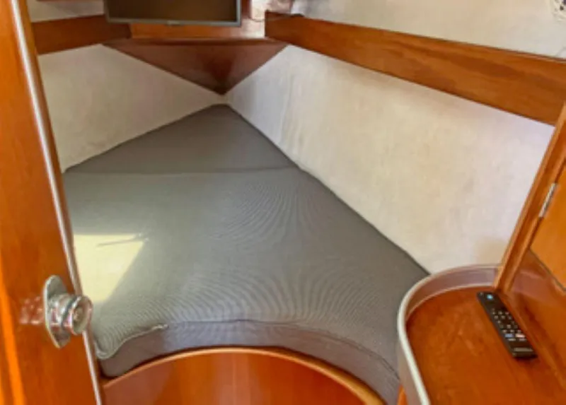 Slide: The Image of Cabin interior of 1991 Beneteau MOORINGS 38 sailboat with cozy bed and wooden finish. - 10