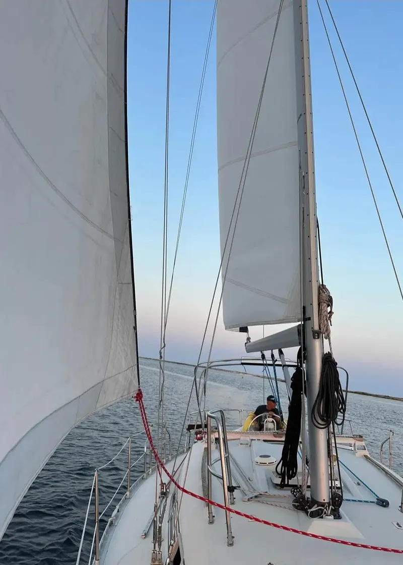 Slide: The Image of Sailing on a 1991 Beneteau MOORINGS 38 yacht with full sails on open water. - 14