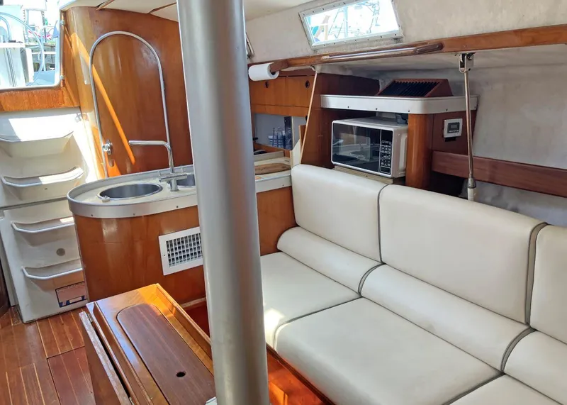 Slide: The Image of Interior of 1991 Beneteau MOORINGS 38 yacht with kitchen and seating area. - 4