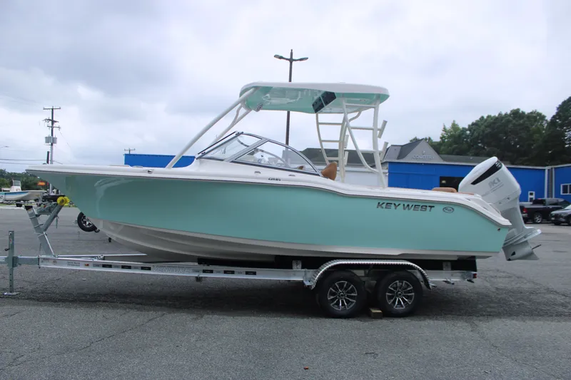 The Image of 2026 Key West 239 DFS boat on trailer, light blue hull, parked outdoors. - 0