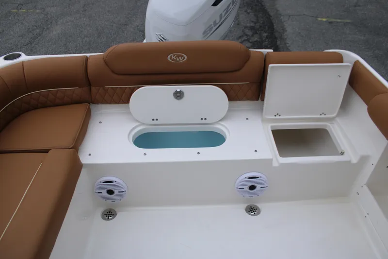 Slide: The Image of 2026 Key West 239 DFS boat interior with tan seating and storage compartments. - 15