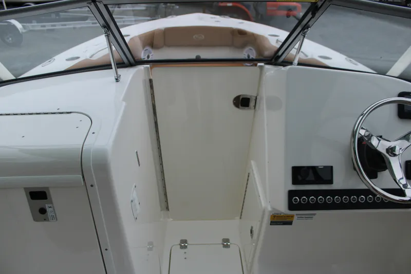 Slide: The Image of 2026 Key West 239 DFS boat interior with steering wheel and dashboard controls. - 21