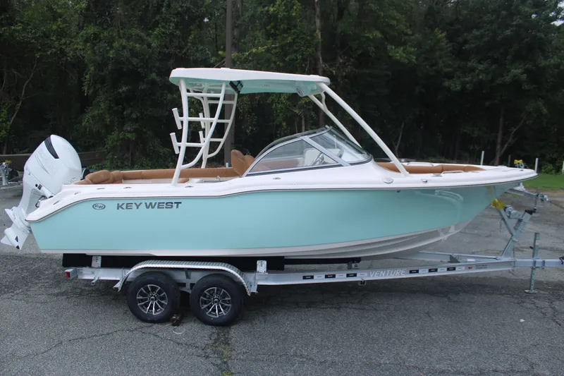 Slide: The Image of 2026 Key West 239 DFS boat on trailer, light blue hull, parked outdoors. - 4