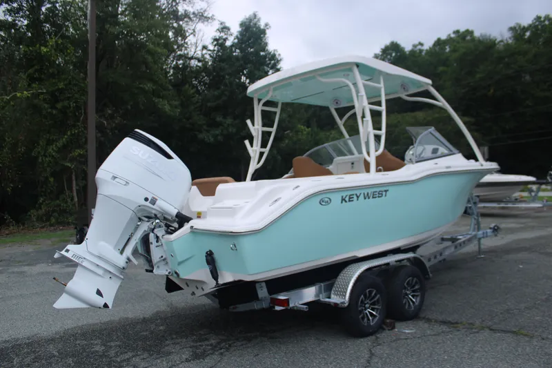 Slide: The Image of 2026 Key West 239 DFS boat on trailer, featuring a Suzuki outboard motor. - 5