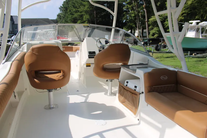 Slide: The Image of 2026 Key West 239 DFS boat interior with tan seating and modern dashboard. - 9