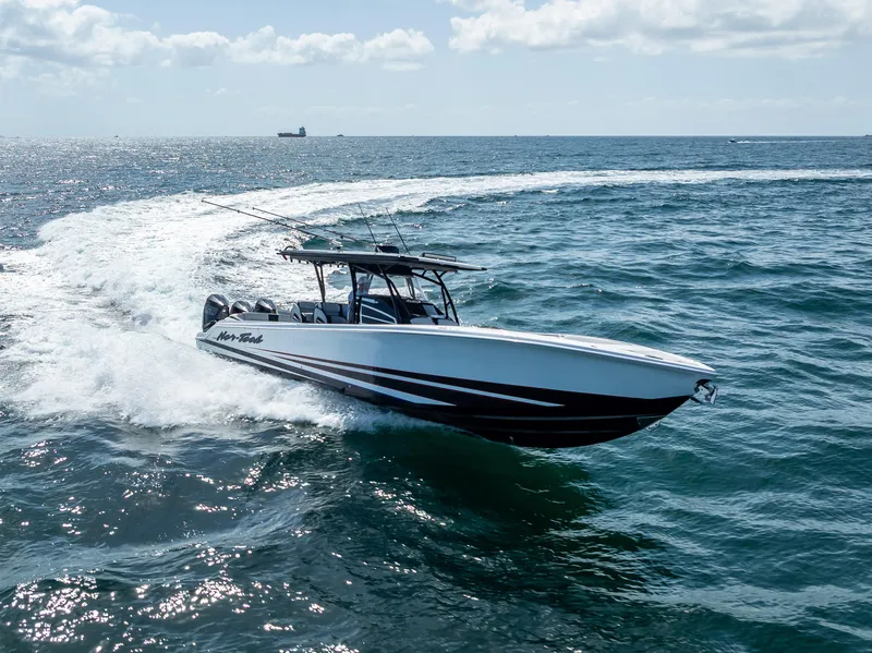 Slide: The Image of 2022 Nor-Tech 390 Sport Center Console boat cruising on open ocean. - 18