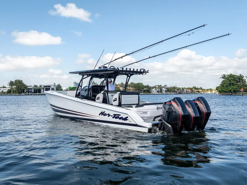Slide: The Image of 2022 Nor-Tech 390 Sport Center Console boat cruising on a sunny day. - 2