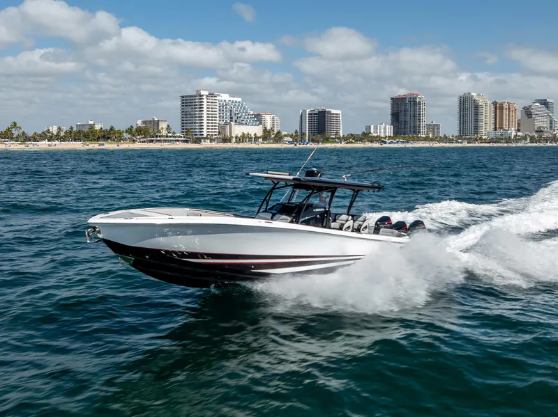 Slide: The Image of 2022 Nor-Tech 390 Sport Center Console cruising near city skyline. - 20