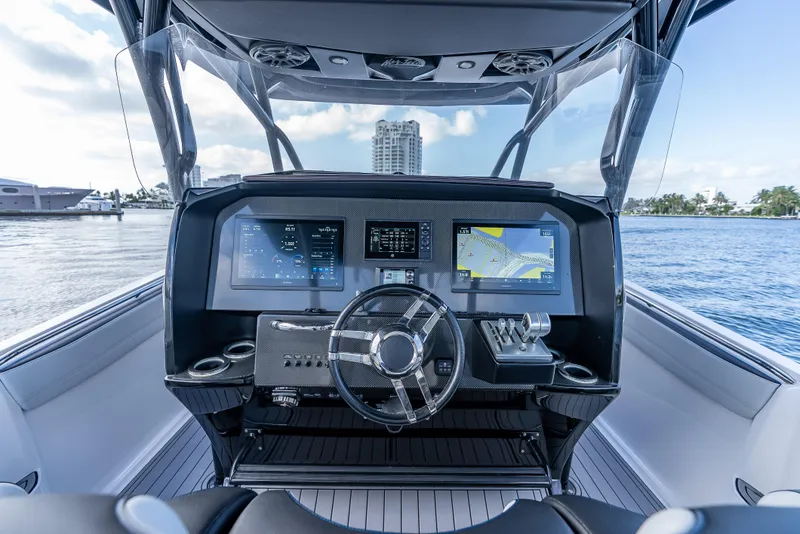 Slide: The Image of 2022 Nor-Tech 390 Sport Center Console dashboard with advanced navigation displays on the water. - 22