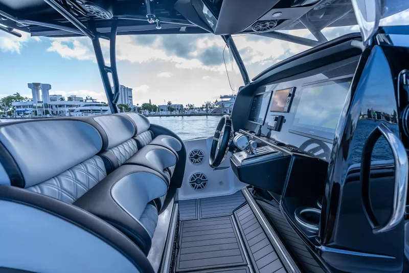 Slide: The Image of 2022 Nor-Tech 390 Sport Center Console interior with luxurious seating and advanced dashboard. - 24