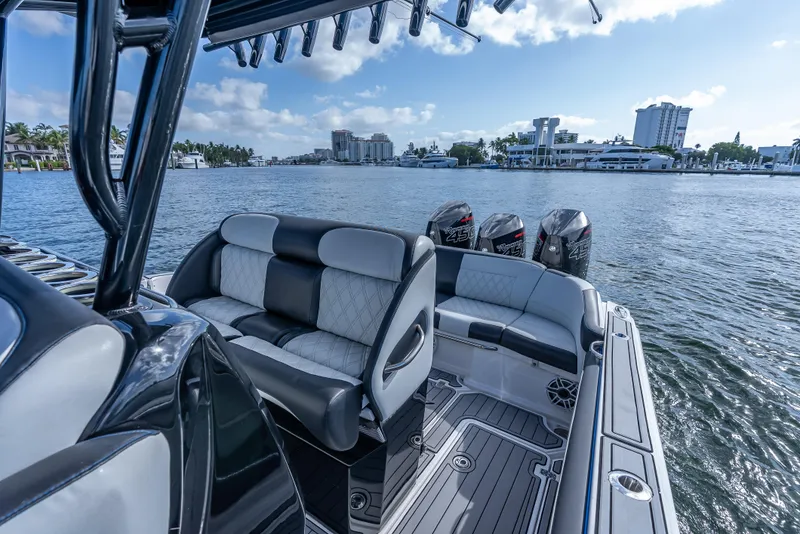 Slide: The Image of 2022 Nor-Tech 390 Sport Center Console boat with luxurious seating and powerful engines on the water. - 29