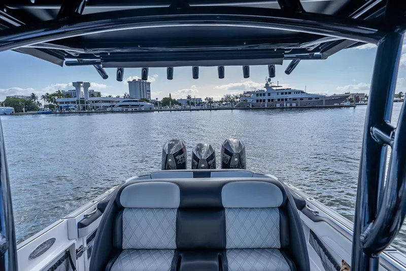 Slide: The Image of 2022 Nor-Tech 390 Sport Center Console on water, showcasing luxury seating and powerful engines. - 30