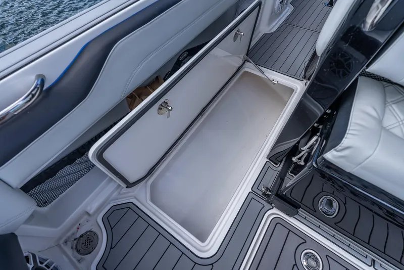 Slide: The Image of 2022 Nor-Tech 390 Sport Center Console storage compartment with sleek interior design. - 31