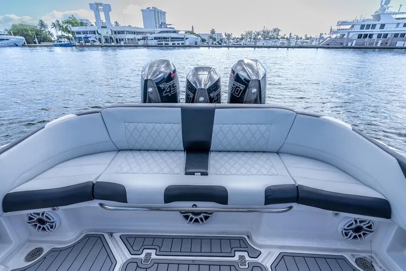 Slide: The Image of 2022 Nor-Tech 390 Sport Center Console with triple engines, luxurious seating, and waterfront view. - 33