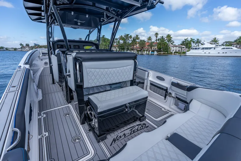 Slide: The Image of 2022 Nor-Tech 390 Sport Center Console boat interior with luxurious seating and scenic waterfront view. - 42