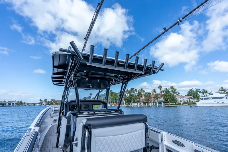 Slide: The Image of 2022 Nor-Tech 390 Sport Center Console boat on a sunny day, with palm trees in the background. - 43