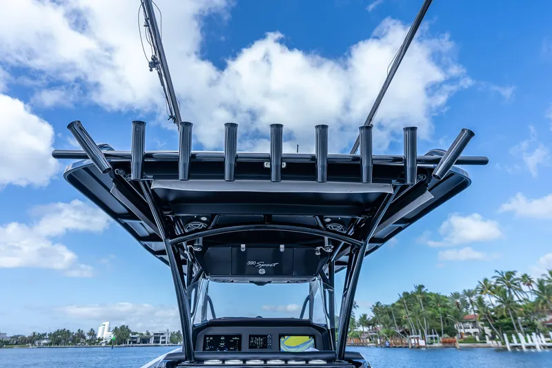 Slide: The Image of 2022 Nor-Tech 390 Sport Center Console boat against a clear blue sky. - 44